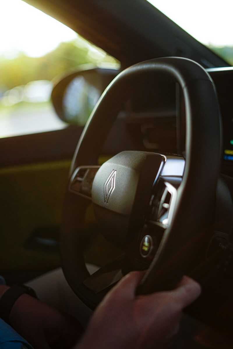 Driver's hands on a car steering wheel